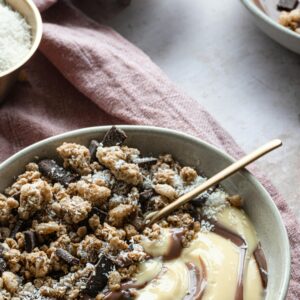 Close-up of a granola and chocolate dessert bowl with creamy texture for a delightful treat.