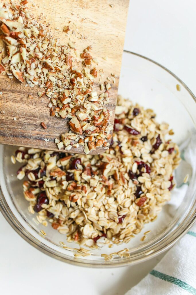 Top view of granola with nuts and raisins in a bowl, perfect for a healthy breakfast.