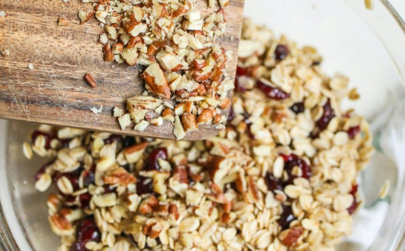 Top view of granola with nuts and raisins in a bowl, perfect for a healthy breakfast.