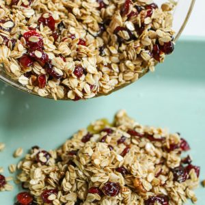 pexels-photo-3872436-3872436 Close-up of homemade granola with oats and cranberries pouring from a bowl.